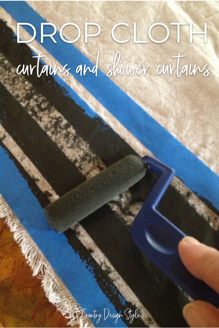 drop cloth with painters tape and paint roller applying black paint.