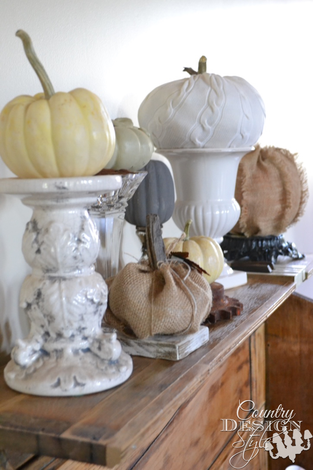 Give a pumpkin a lift. Place on candleholders vase or urn, rusty gear, chunk or wood or the base of a vintage lamp. | countrydesignstyle.com