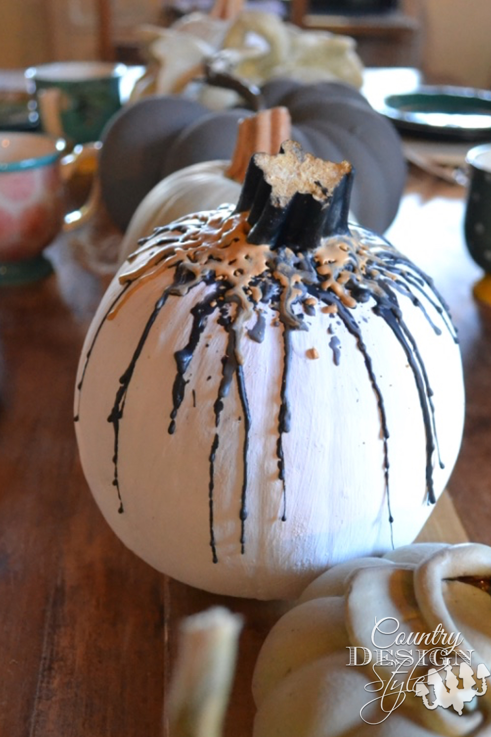Pumpkin with melted crayon in fall colors to display on Thanksgiving table. | countrydesignstyle.com