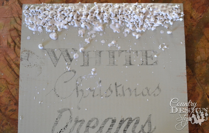 Scrap wood made into Christmas sign with chalk based paint, image transfer, and melting crayon art for melting snow. | countrydesignstyle.com