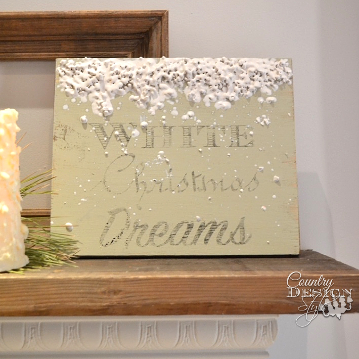 Scrap wood made into Christmas sign with chalk based paint, image transfer, and melting crayon art for melting snow. | countrydesignstyle.com