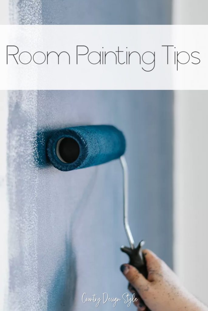 Paint roller with blue paint on wall