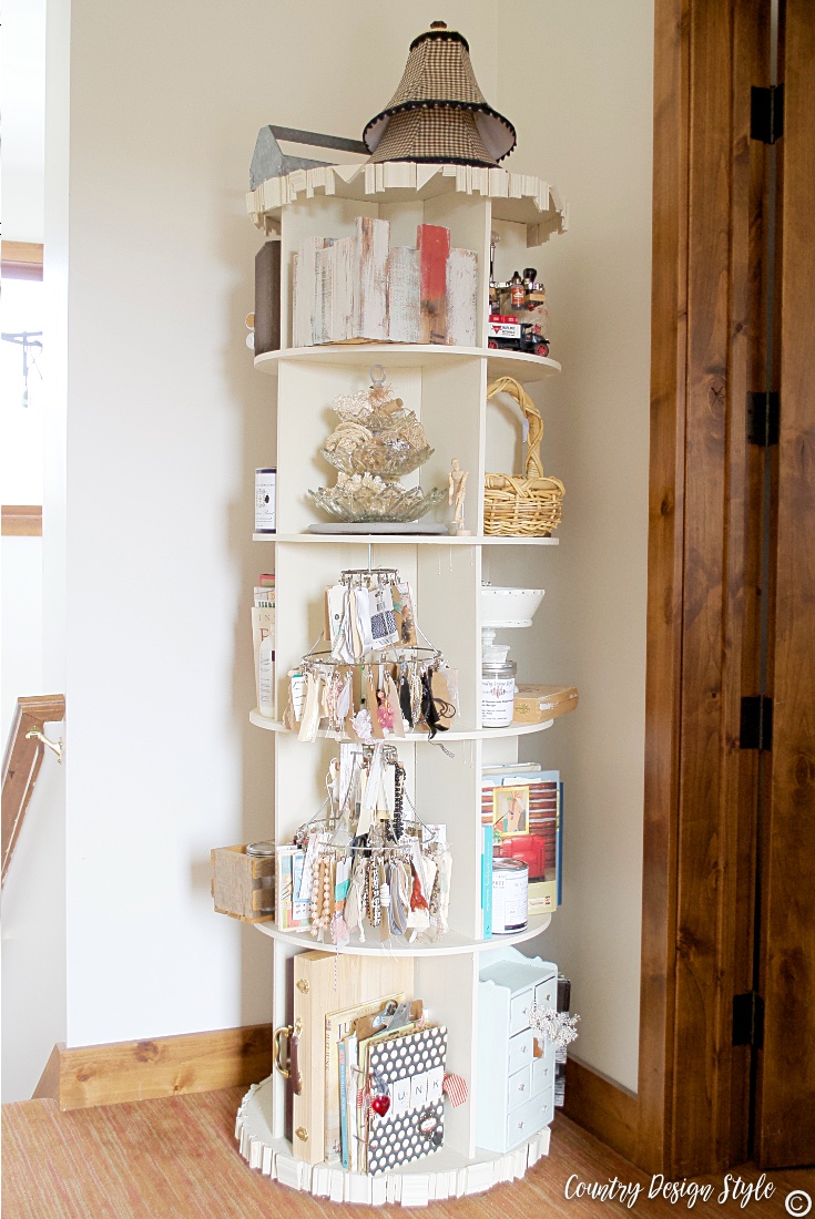 Revolving bookcase filled with craft supplies