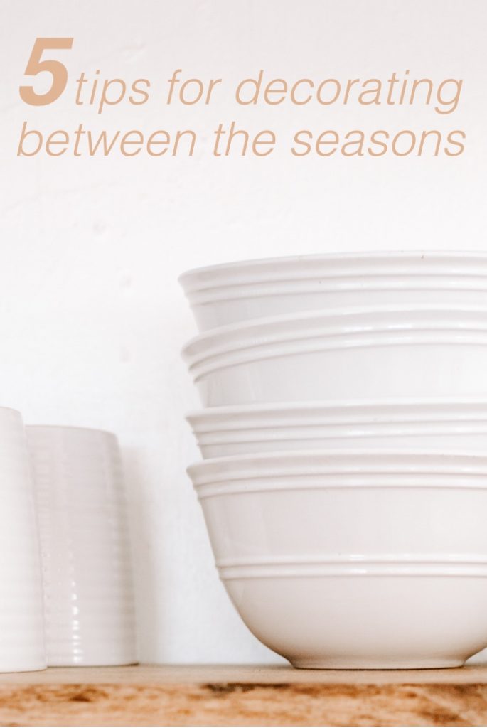 white cups and white bowls on wood shelf