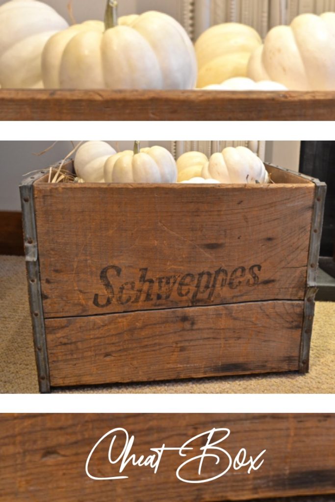 Wooden crate filled with white pumpkins