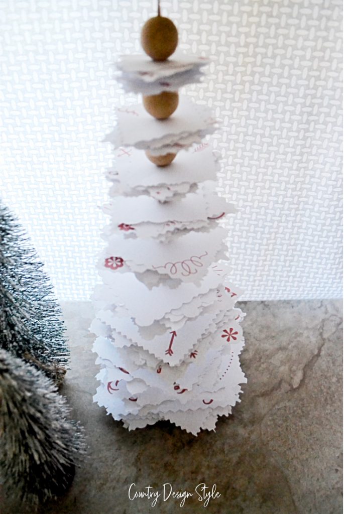 Paper tree with red elements and decorative cut edges. 