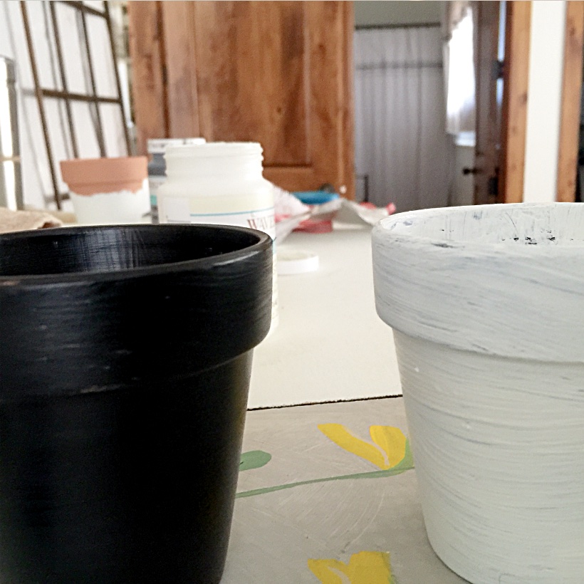 black painted pot and white painted pot