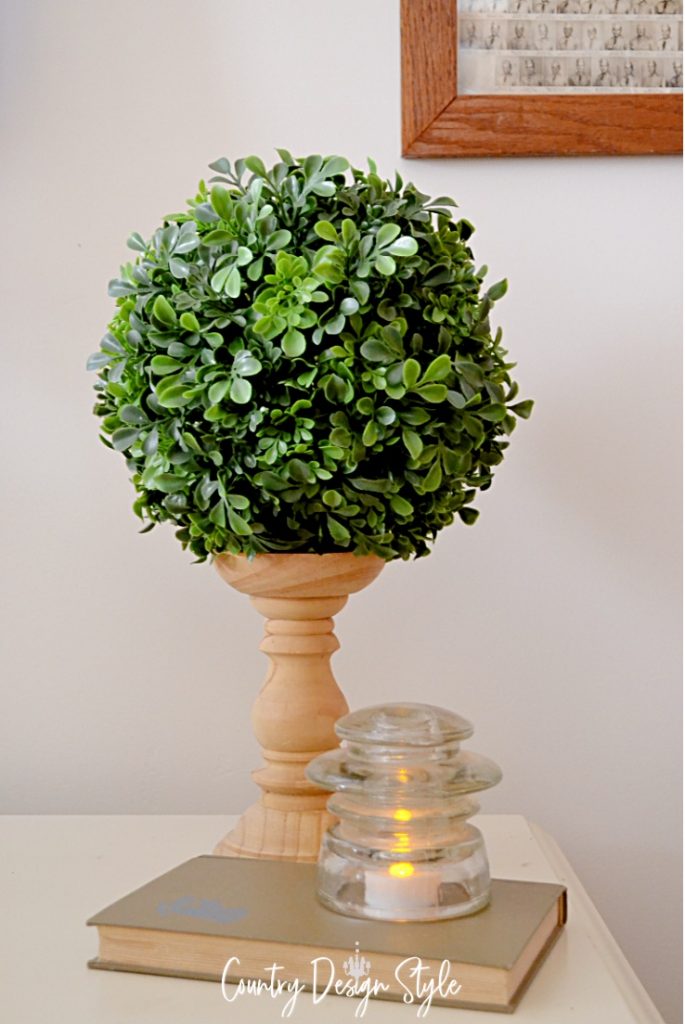 candleholder with round ball of faux greens on top