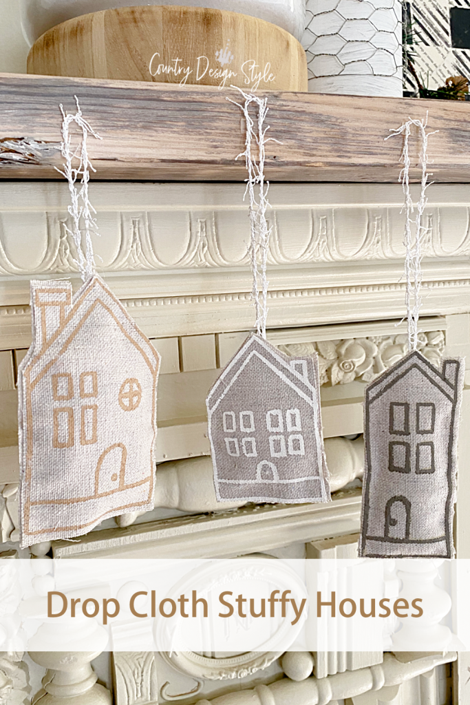 How to make little stuffy houses garland. Fun and creative idea and it's super easy. #CountryDesignStyle #EuropeanFarmhouseStyle #EasyDIYProjects #DIYProjects #DIYHomeDecor #chalkcouture #DropClothProject #DIYDropClothCraft 